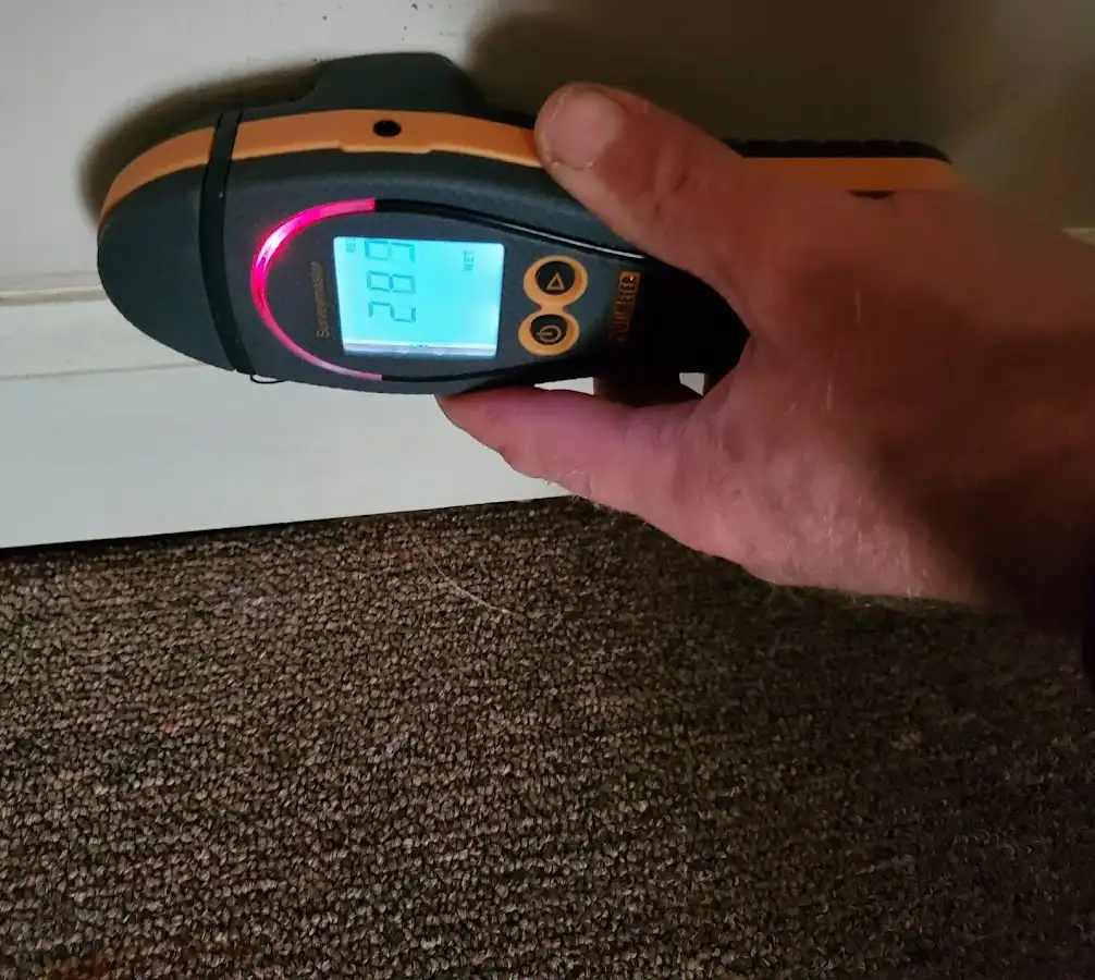 Moisture detection at baseboard during Storm Damage Restoration in Lake Butler